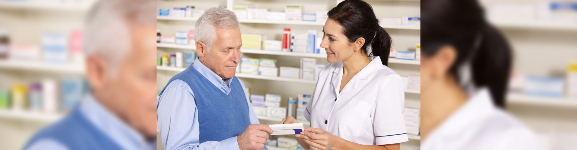 pharmacist serving senior man in pharmacy